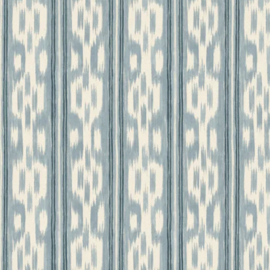 A close-up of a fabric or wallpaper pattern featuring vertical stripes with an ikat-like motif in light blue and off-white.