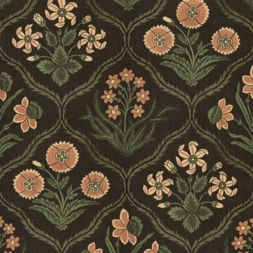 A close-up of a woven floral textile pattern on a dark brown background, featuring peach flowers, green leaves, and olive-green scrolling vines.
