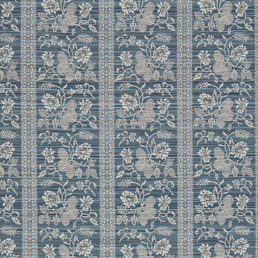 A close-up of a woven fabric or wallpaper pattern featuring vertical stripes with a floral and botanical design in off-white on a muted slate blue background.